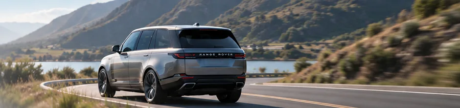 Range Rover driving along a coastal mountain road